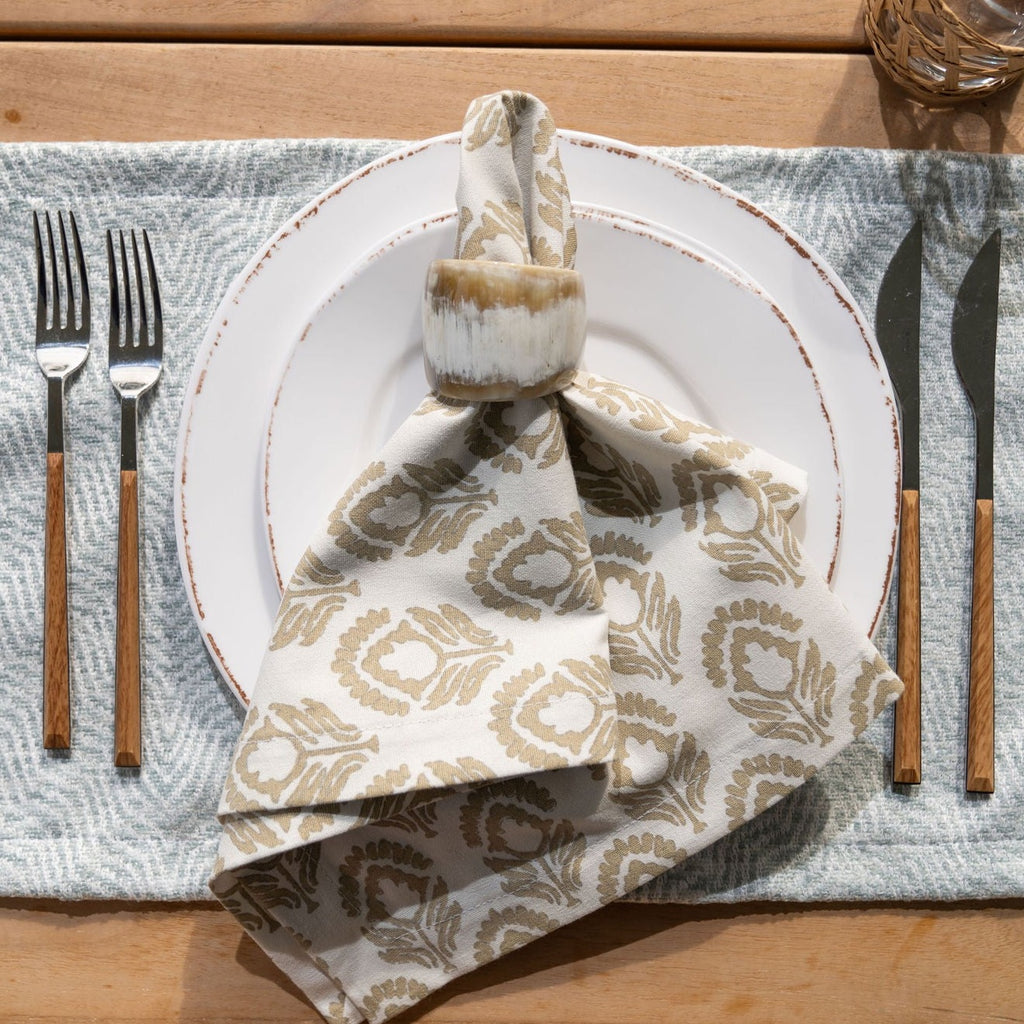 Broad Driftwood Dinner Napkin Displayed with a Stono Coast Placemat on an Outdoor Table