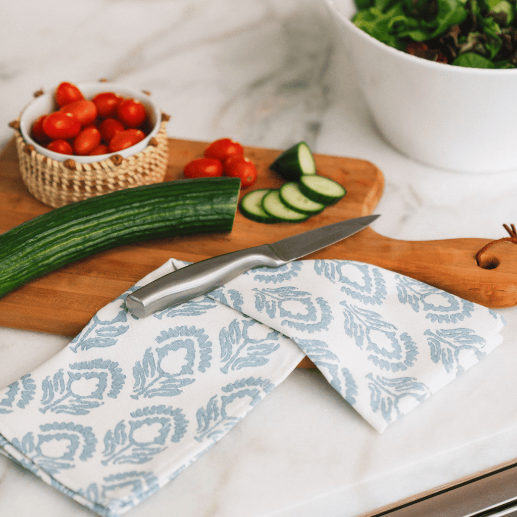 Broad Powder Dinner Napkin Displayed with Cutting Board and Chopped Veggies