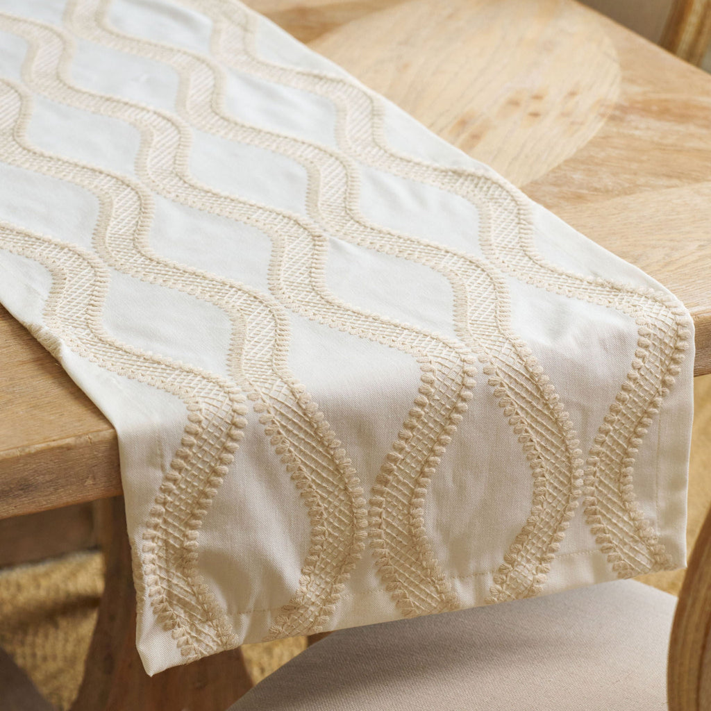 white and tan embroidered table runner