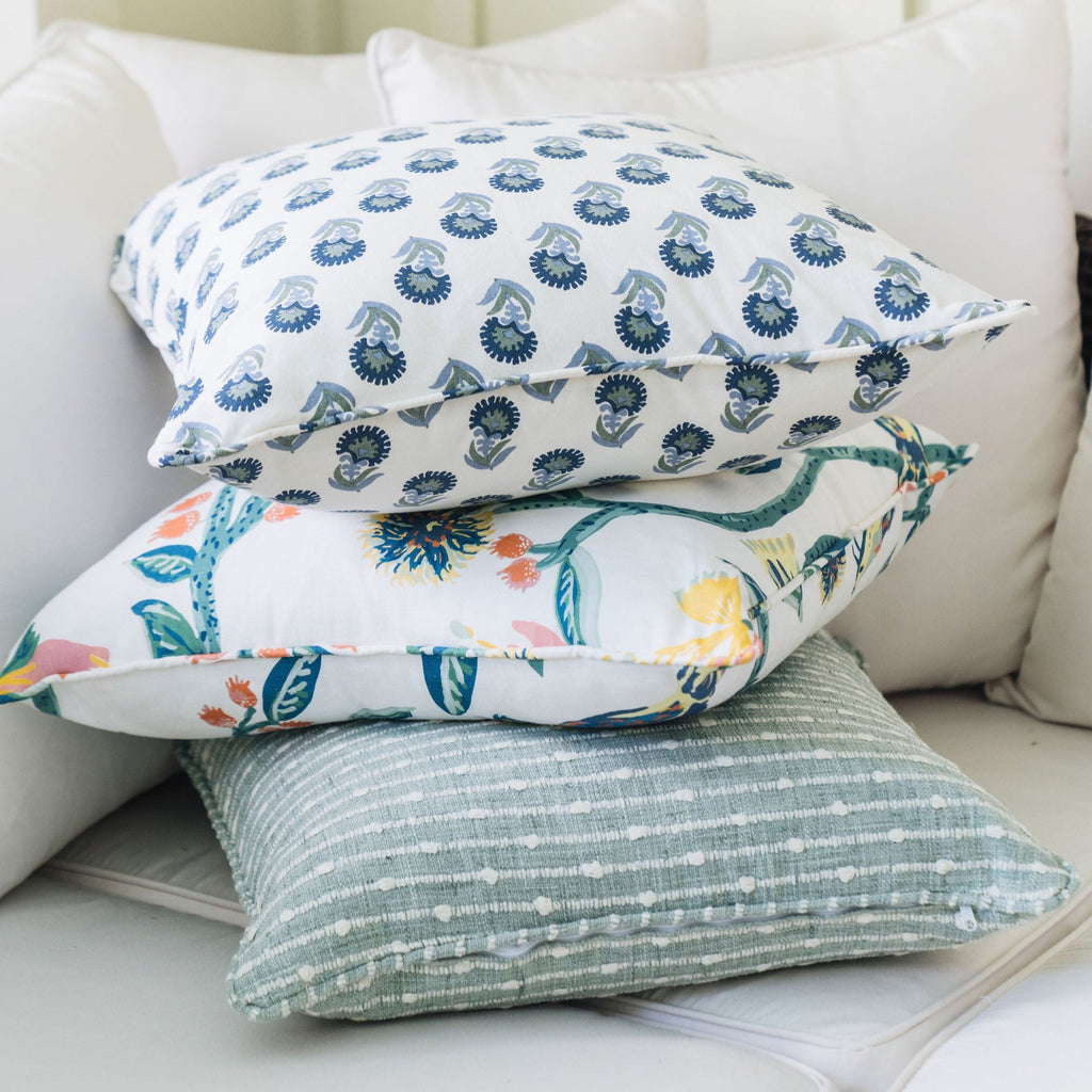 summertime stack of throw pillows. sage, blue, yellow, and pink pillows