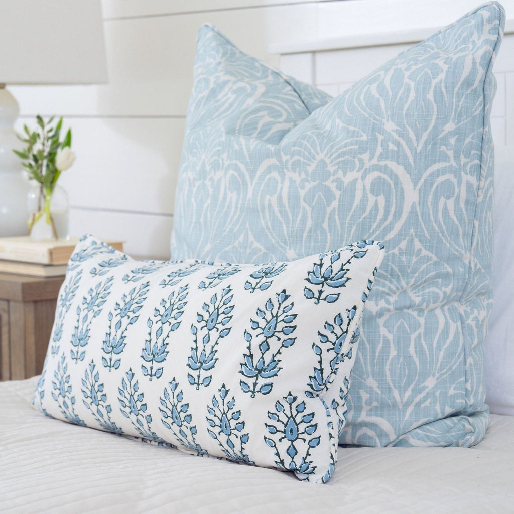 stacked blue and white pillows