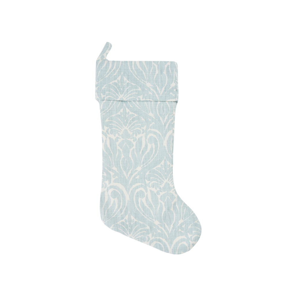 Light blue Christmas stocking with white pattern on a white background